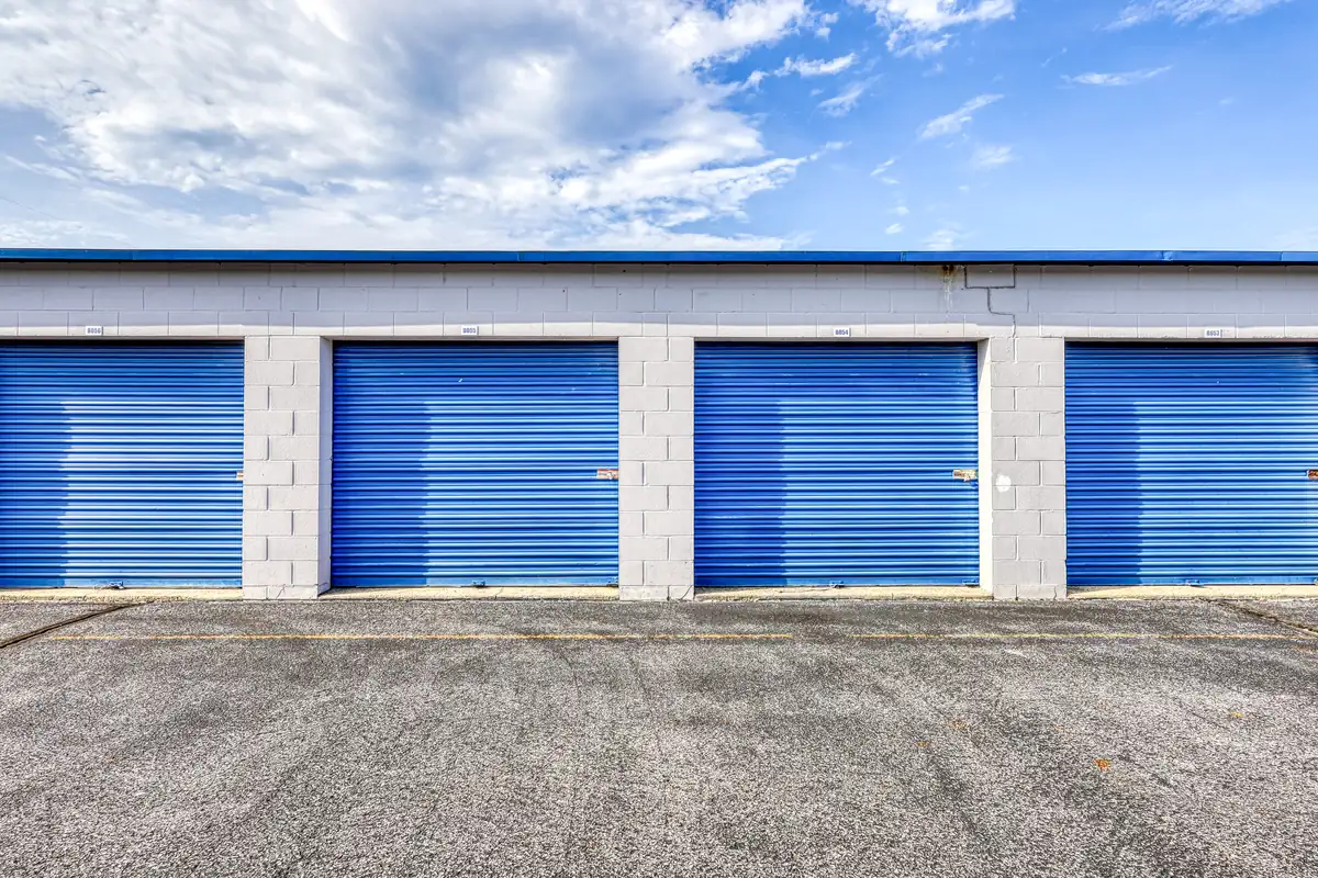 Close-up of two blue exterior roll-up doors for drive-up storage units at the Indianapolis 10th St location.