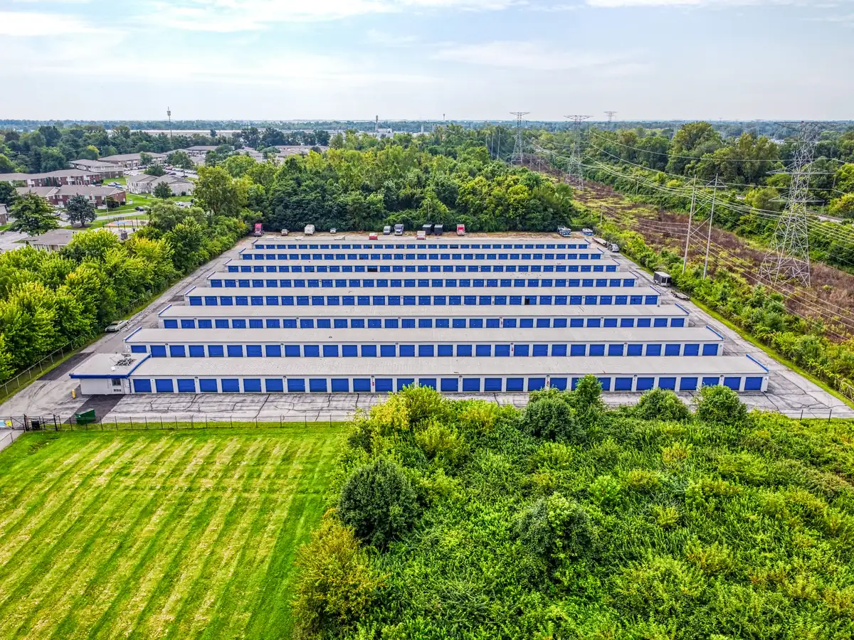 Aerial view showing the blue roofs of the MyPlace Self Storage 10th St facility surrounded by green trees.