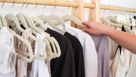 putting clothes on hangers to store for the fall.