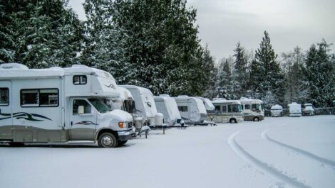 RVs parked during a winter storm.