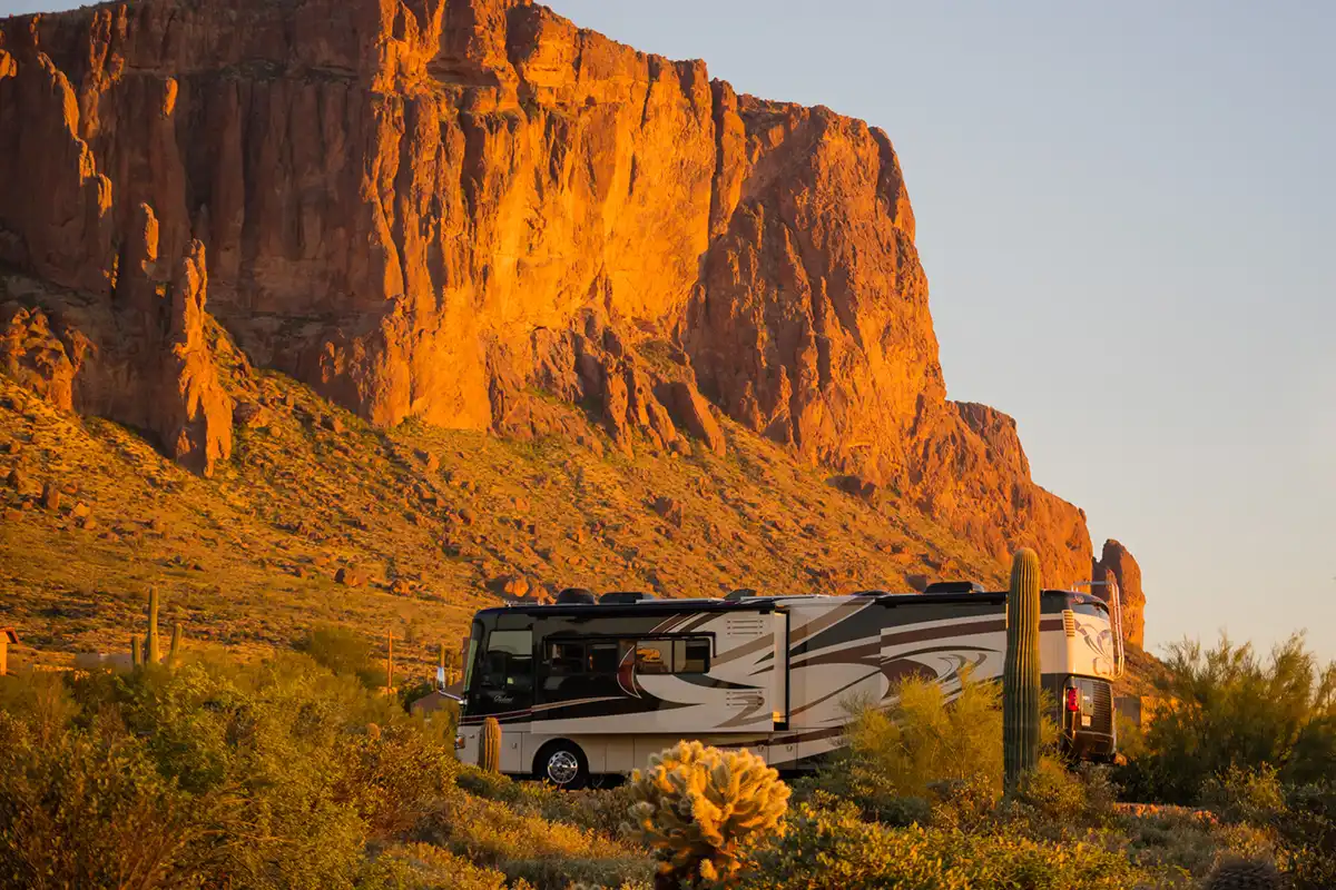 RV, Boat, and Vehicle Storage in Apache Junction: A Snowbird and Adventurer's Guide 2 A large recreational vehicle parked among saguaro cacti at Lost Dutchman State Park in Arizona.