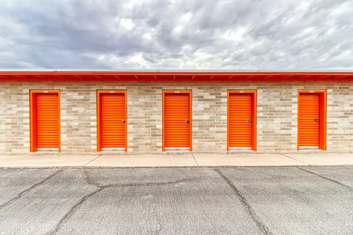 Row of orange roll-up doors on ground-level drive-up units at our Casa Grande facility.