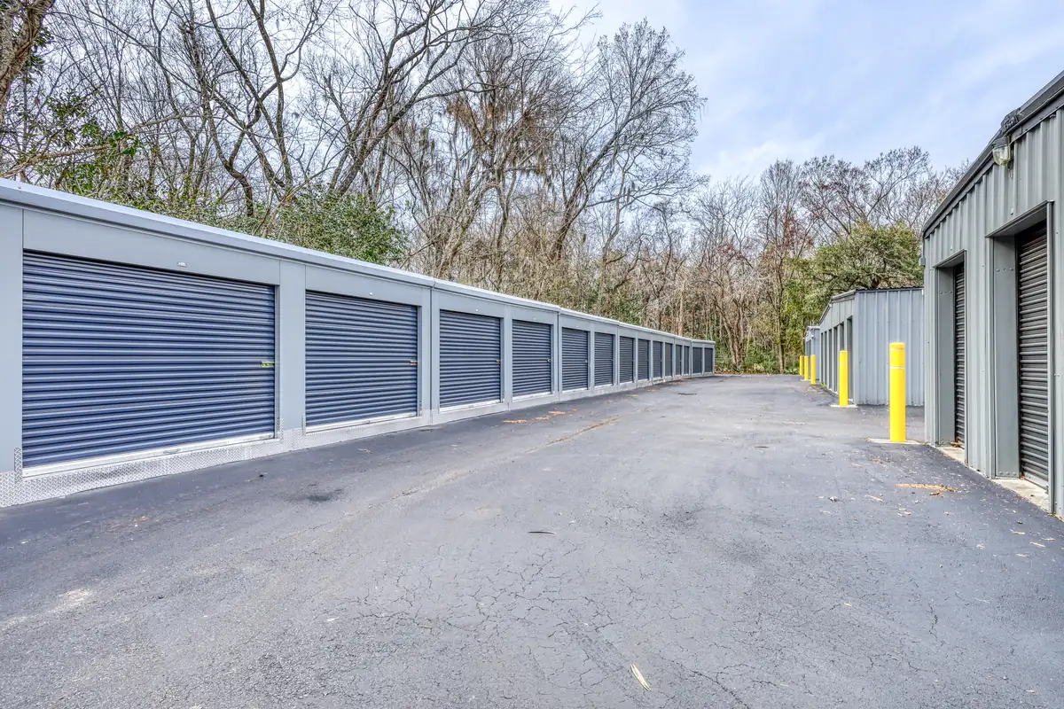 Long row of blue roll-up doors on ground-level drive-up units at MyPlace Self-Storage Charleston.