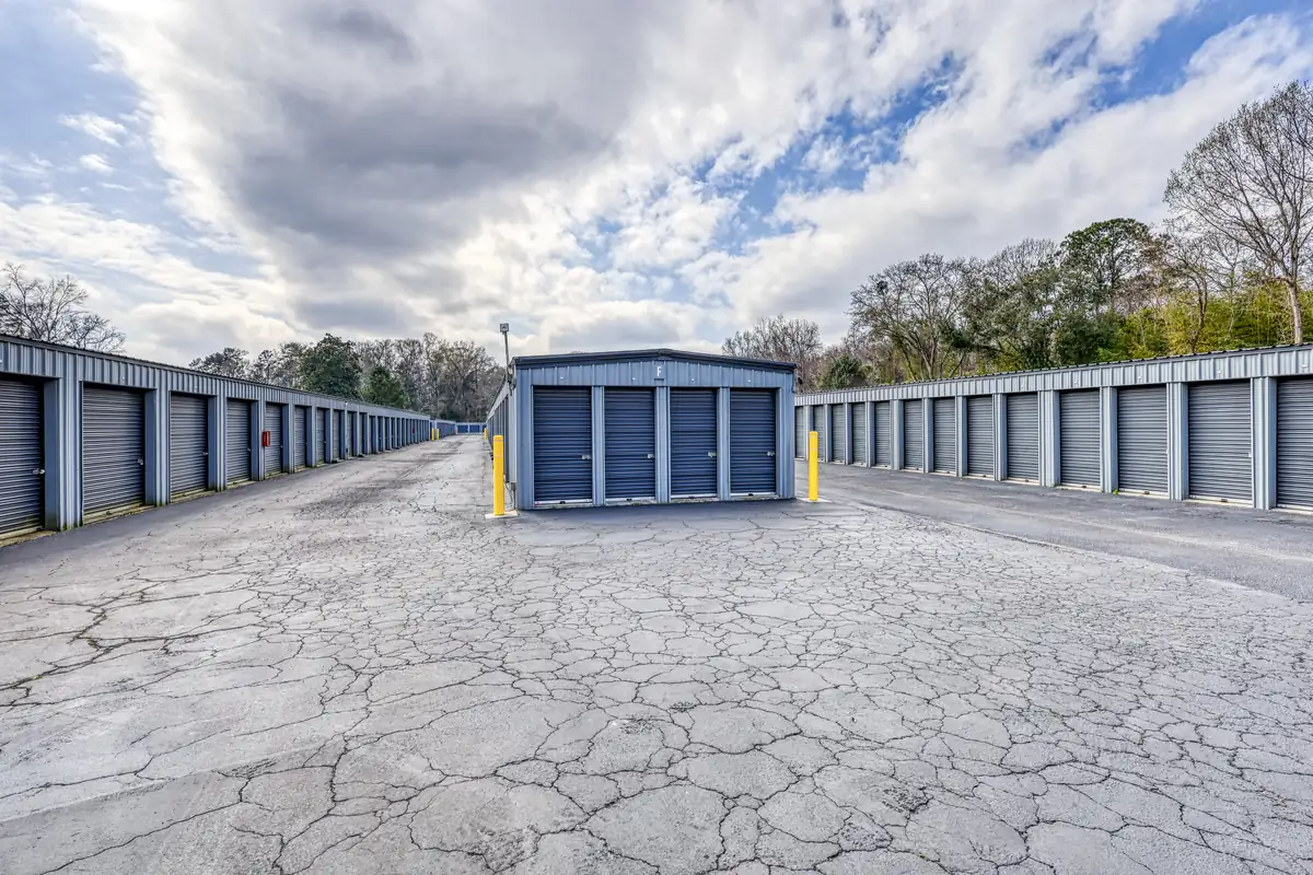 Wide drive aisle between rows of drive-up storage units in Charleston, SC.