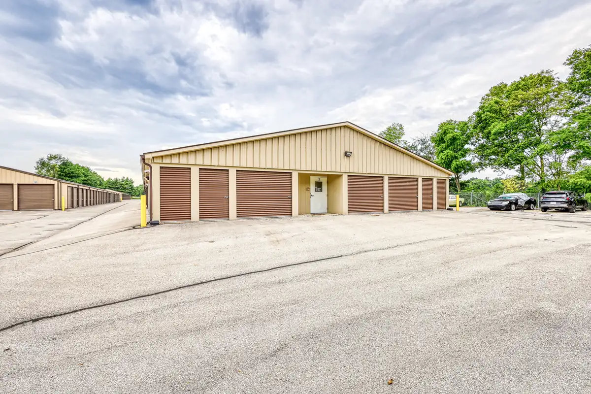 Exterior view of a tan storage building with brown drive-up doors at MyPlace Self Storage in Cicero, IN.