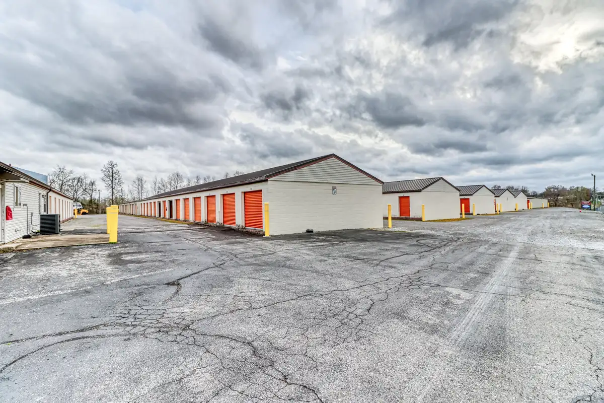 Wide drive aisle between rows of drive-up storage units in Clarksville, Tennessee.
