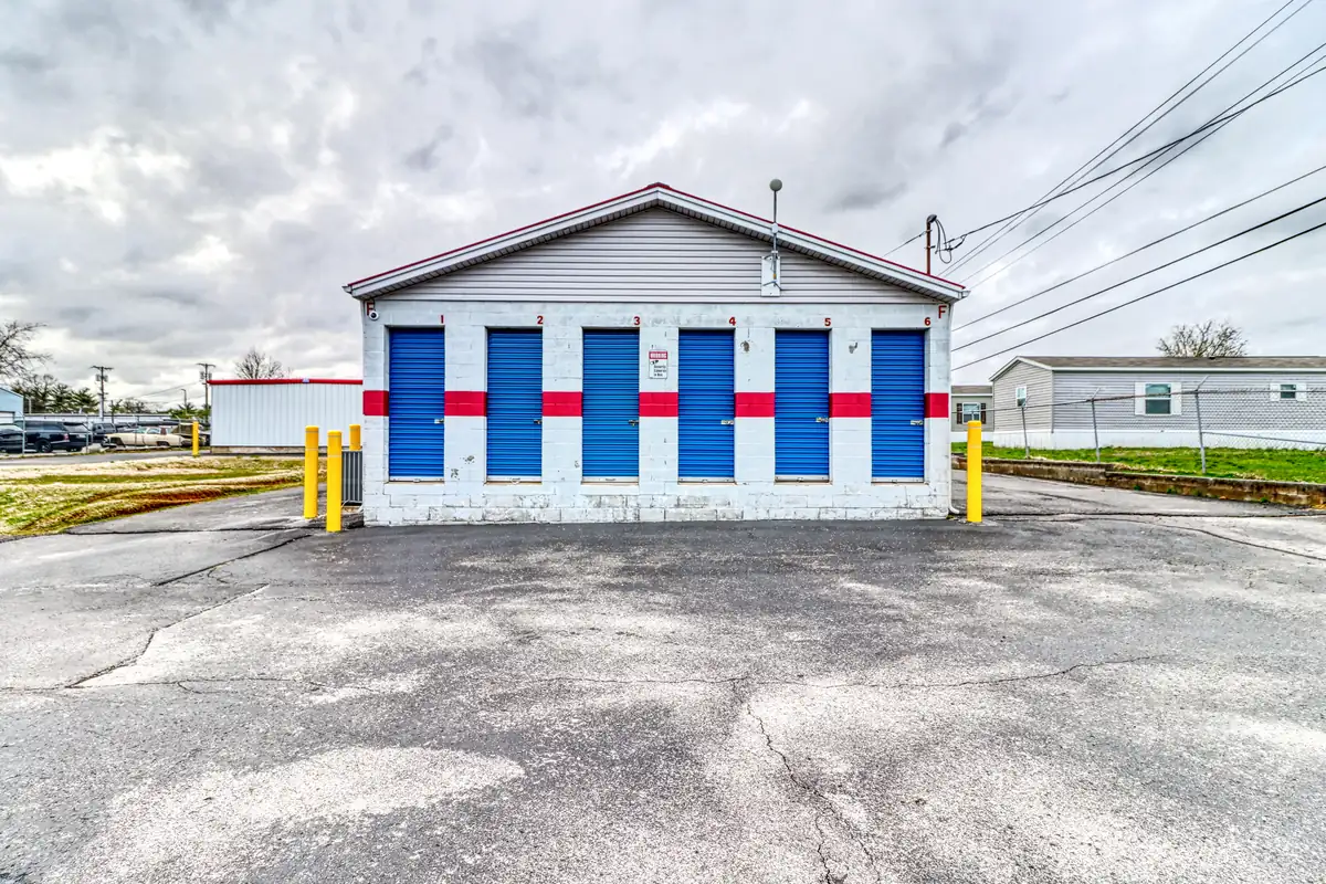 Row of blue roll-up doors on ground-level drive-up units at MyPlace Self-Storage on Collier Road.