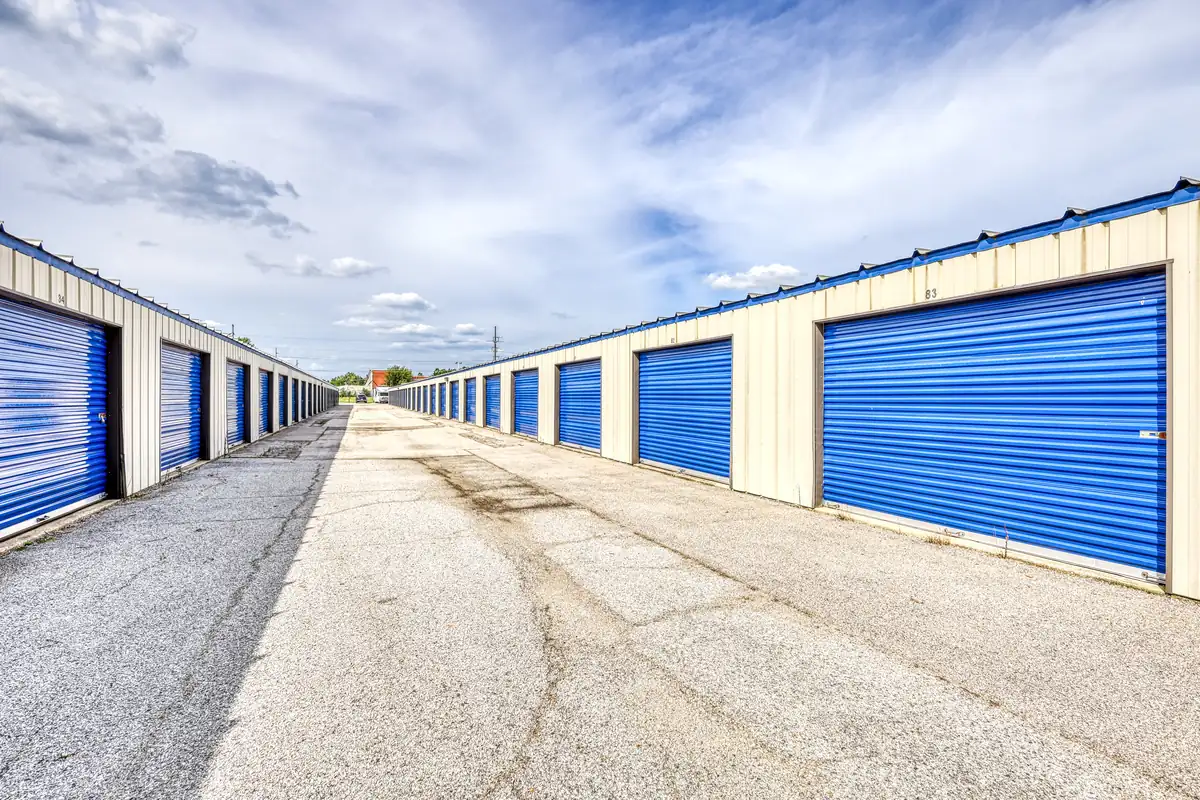 Wide paved drive aisle lined with blue drive-up storage units at the Danville location.