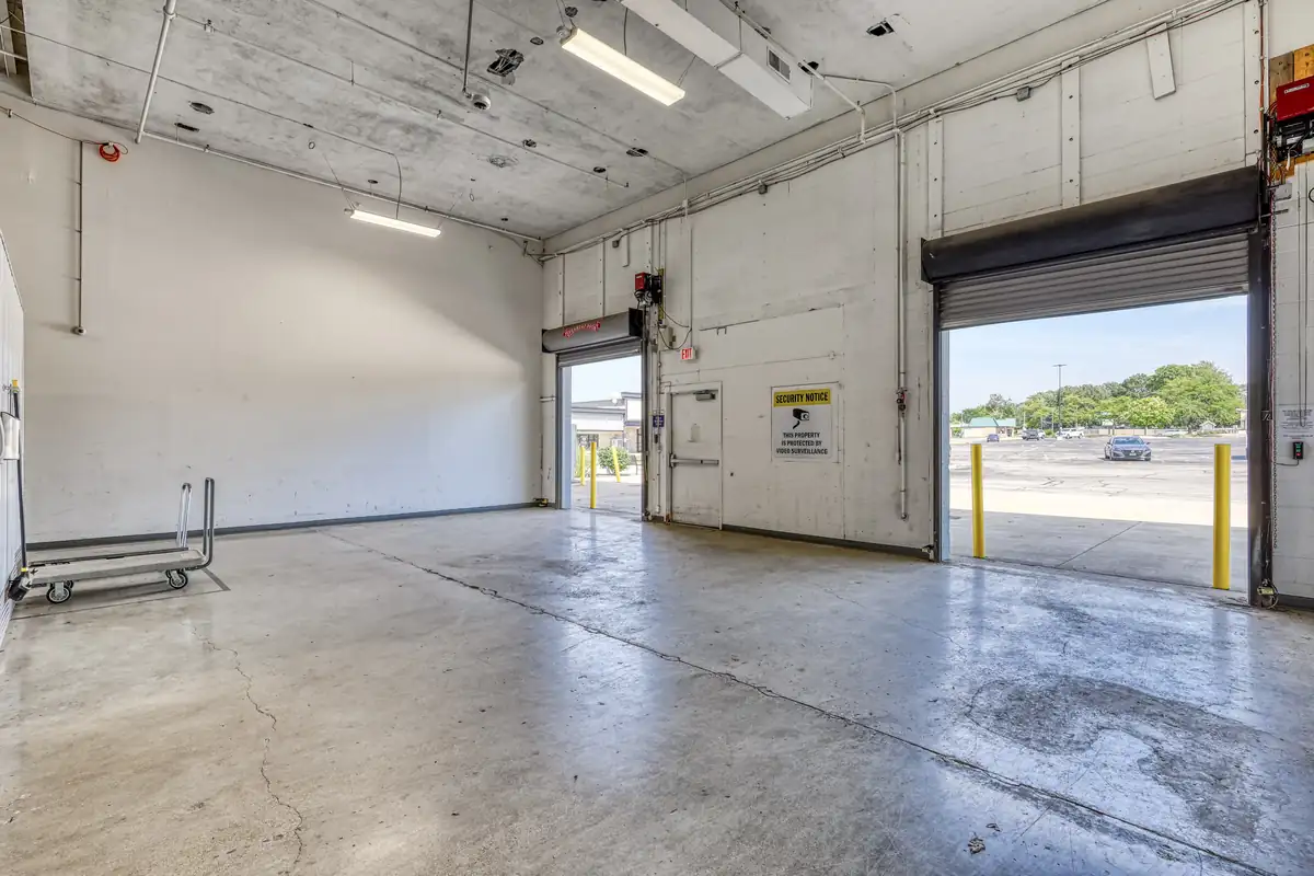 Large, spacious interior loading bay with multiple overhead doors for easy and weather-protected indoor unloading.
