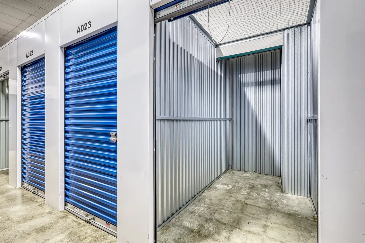 Close-up view inside a clean, empty interior climate-controlled storage unit with corrugated metal walls.