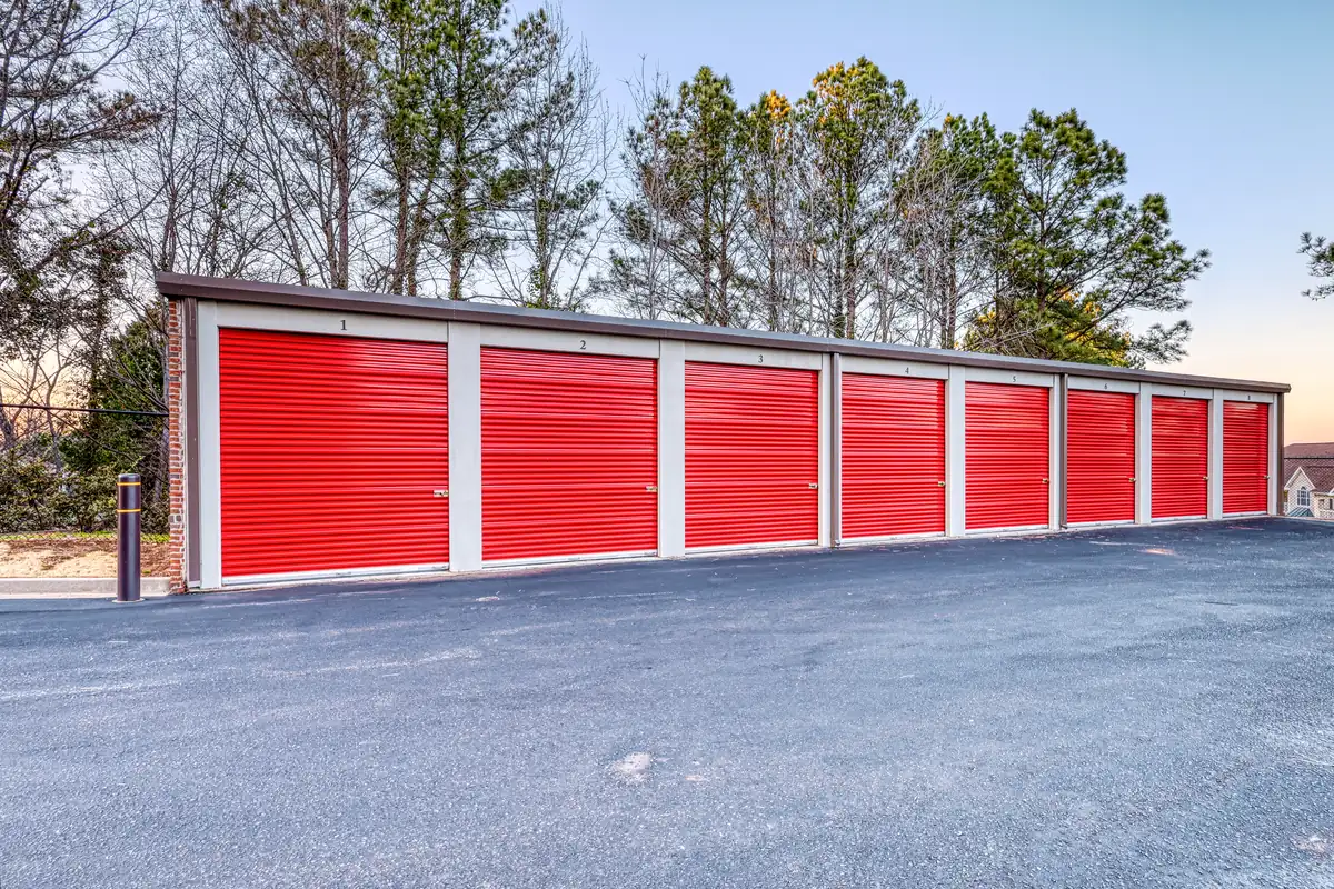 Row of red exterior roll-up doors along the storage building at MyPlace Self-Storage on Pelham Road.