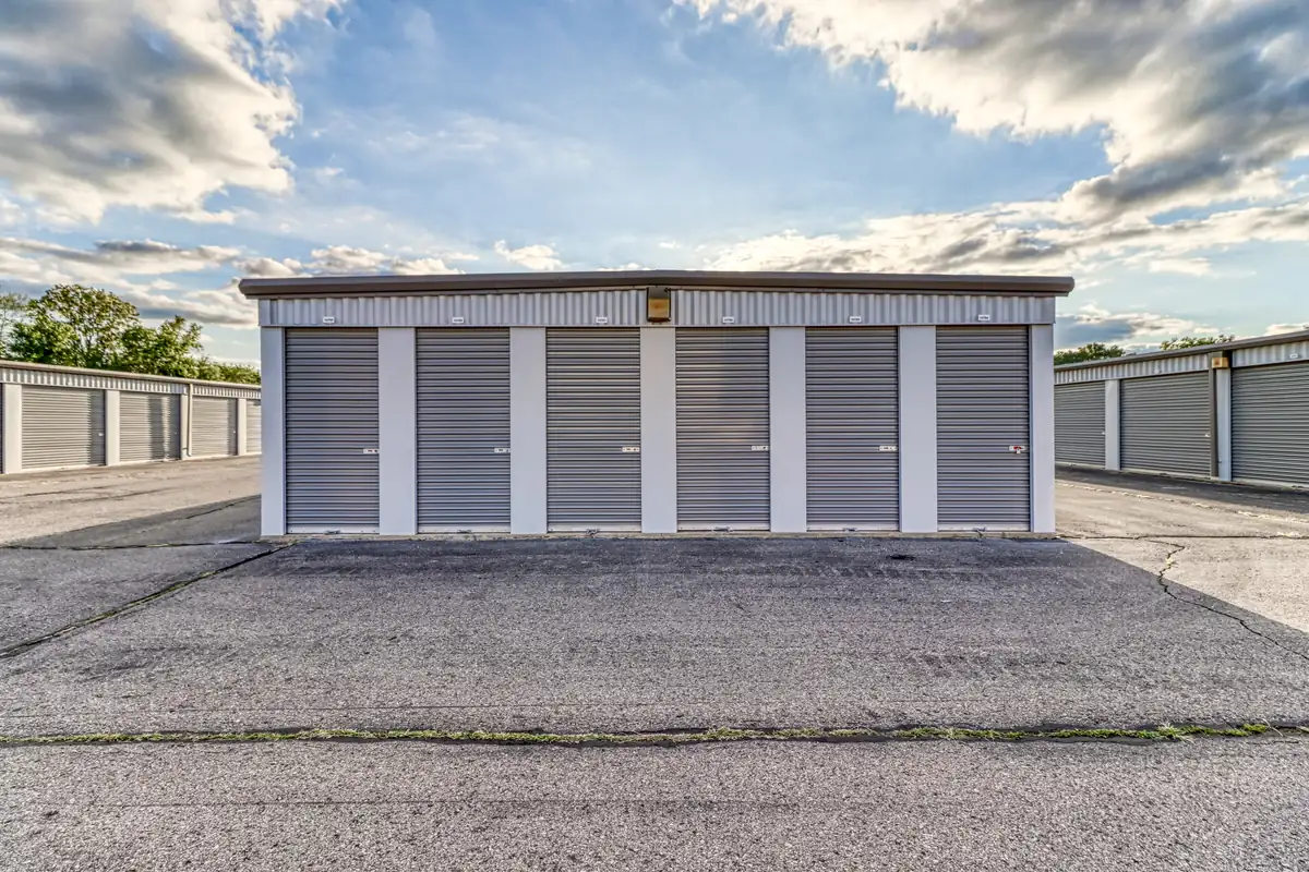 Row of drive-up storage units with roll-up doors facing a paved drive at MyPlace Self-Storage in Westland, MI.