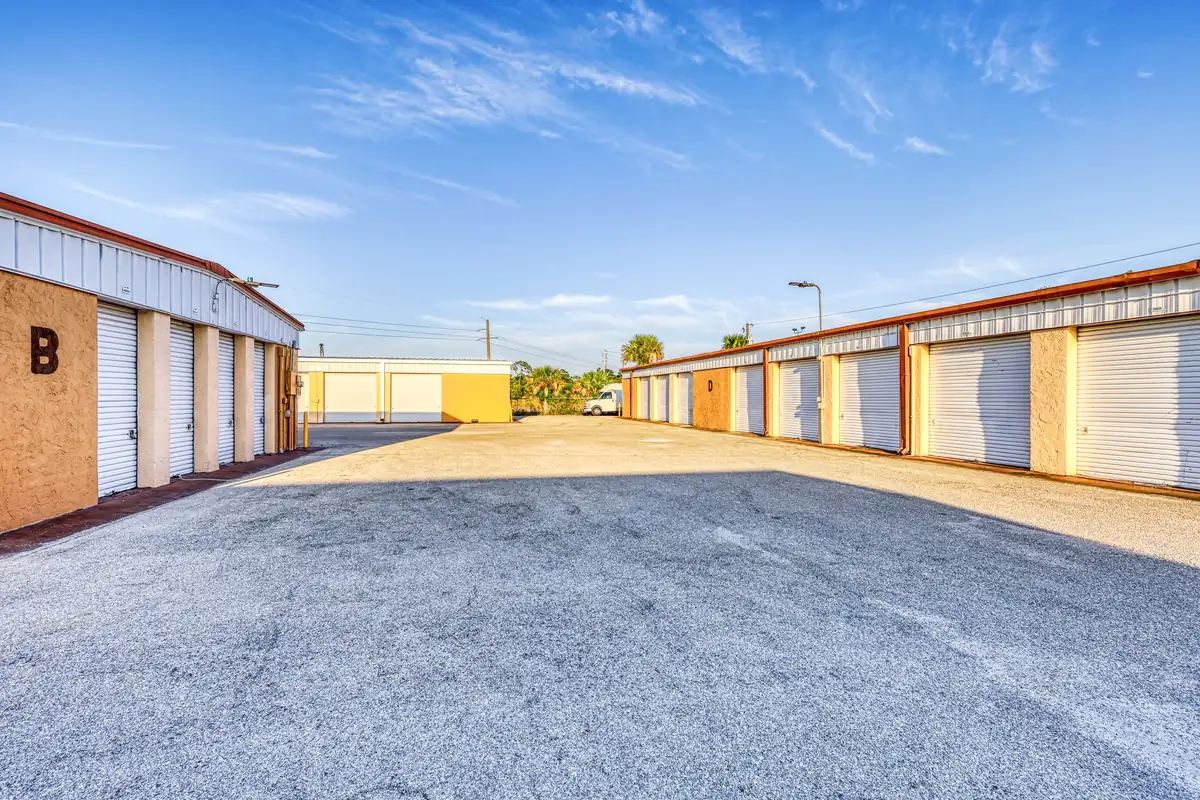 Drive aisle between rows of drive-up storage units at MyPlace Self-Storage Punta Gorda.
