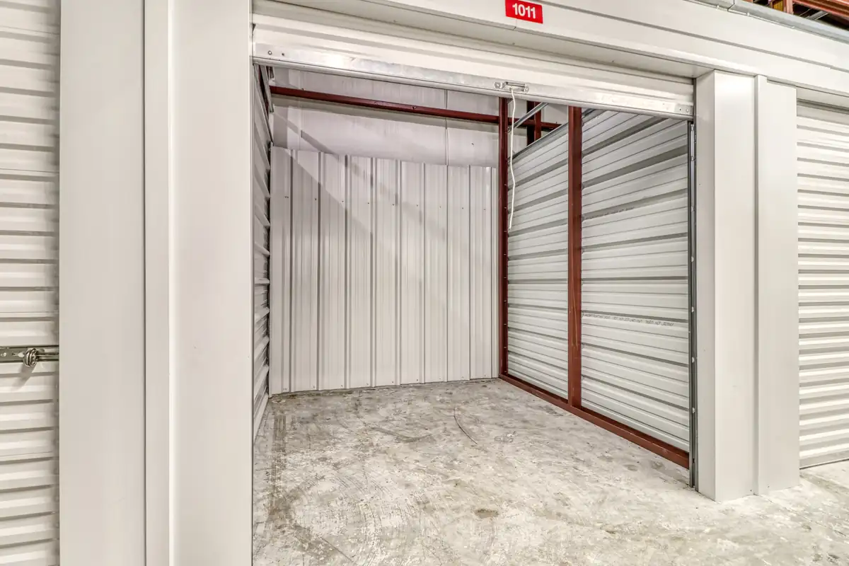 Open empty storage unit with roll-up door at MyPlace Self-Storage on S Monroe Street.