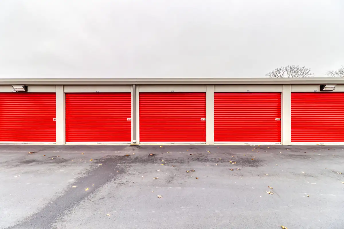Row of red roll-up doors on ground-level drive-up units at MyPlace Self-Storage in West Lafayette, Indiana.